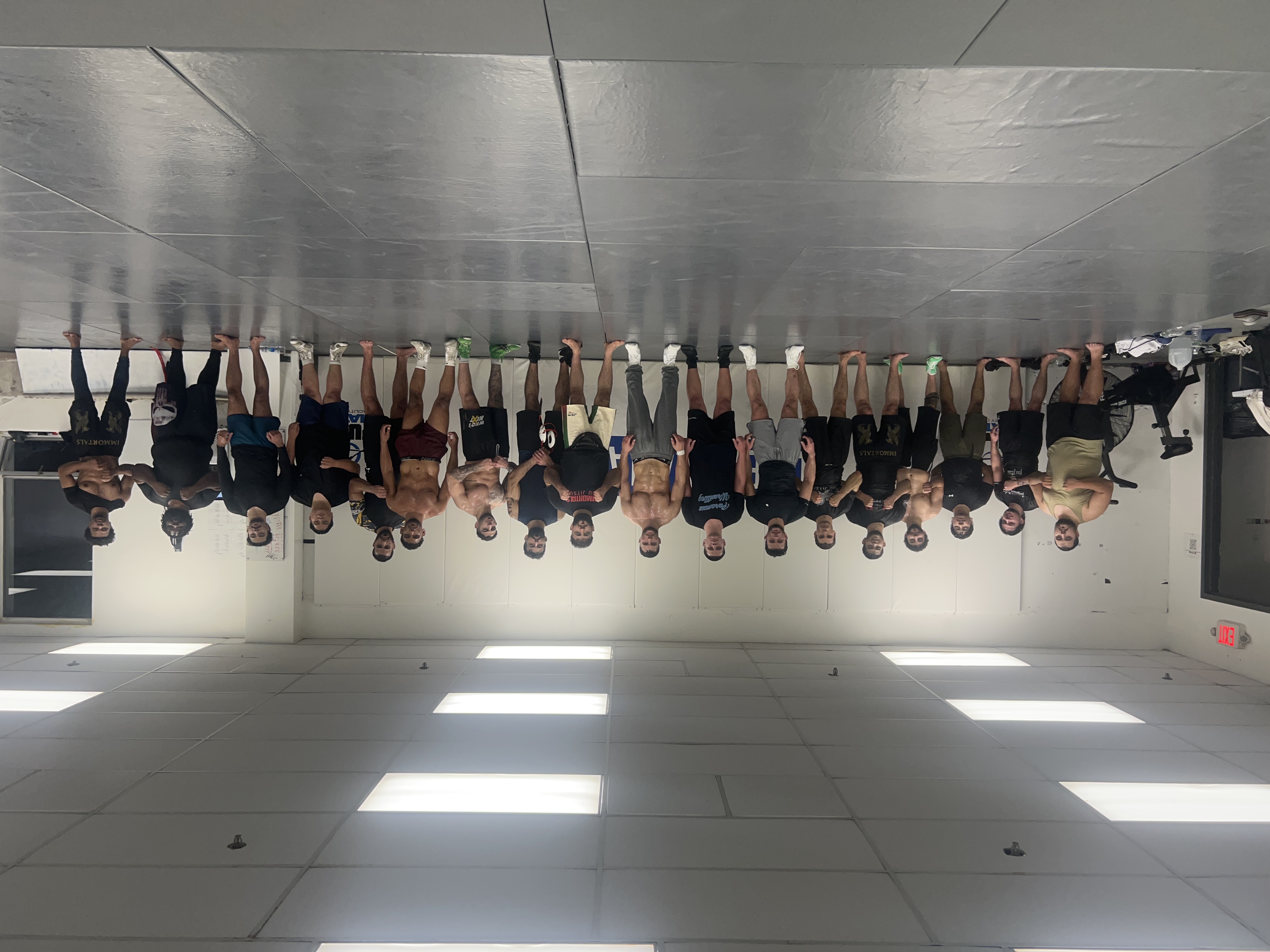 Adult members standing together on the mats after a no-gi jiu jitsu and wrestling session at Immortals in Clifton.