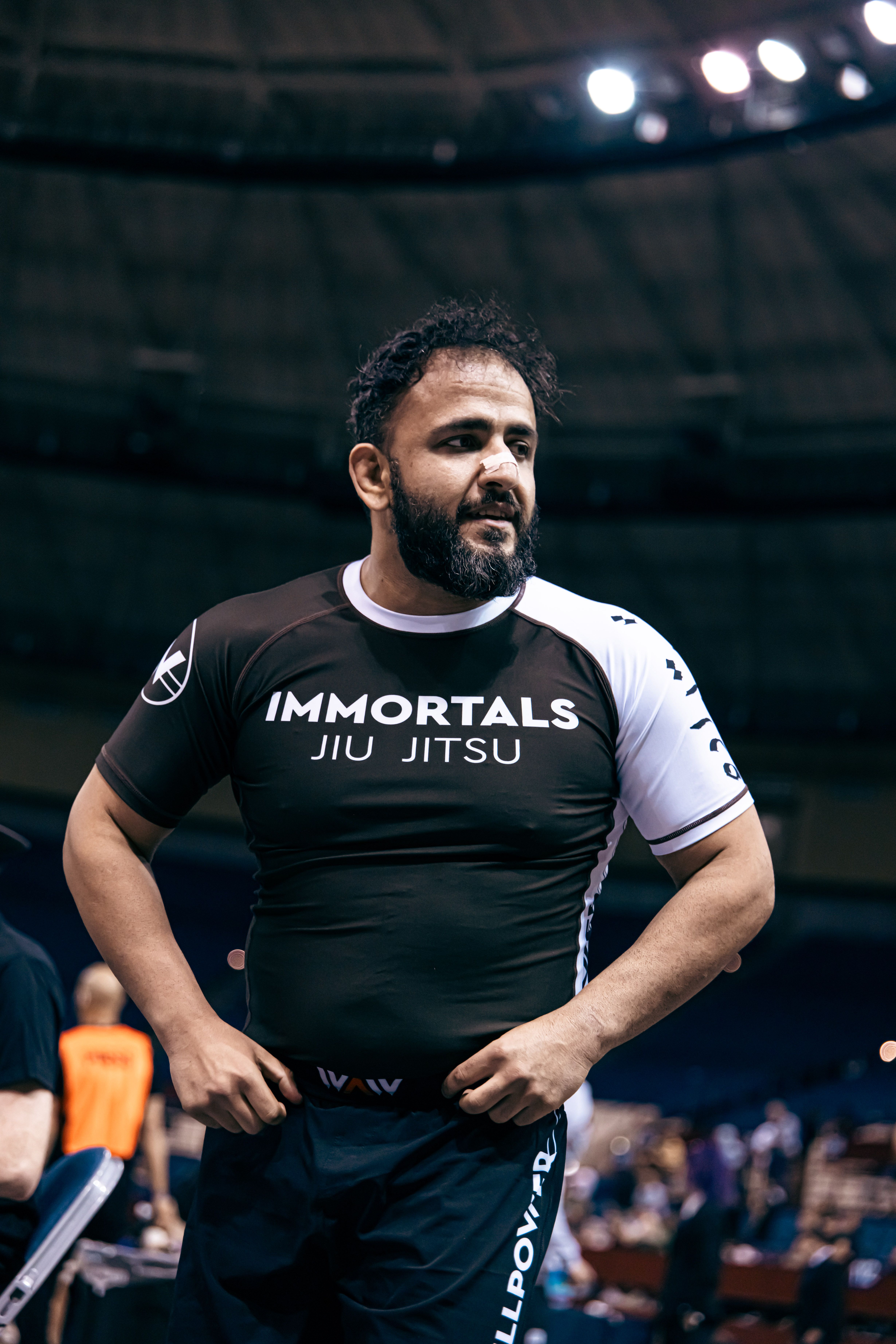Immortals founder Mike Rakshan in an Immortals Jiu Jitsu rashguard at a competition arena.