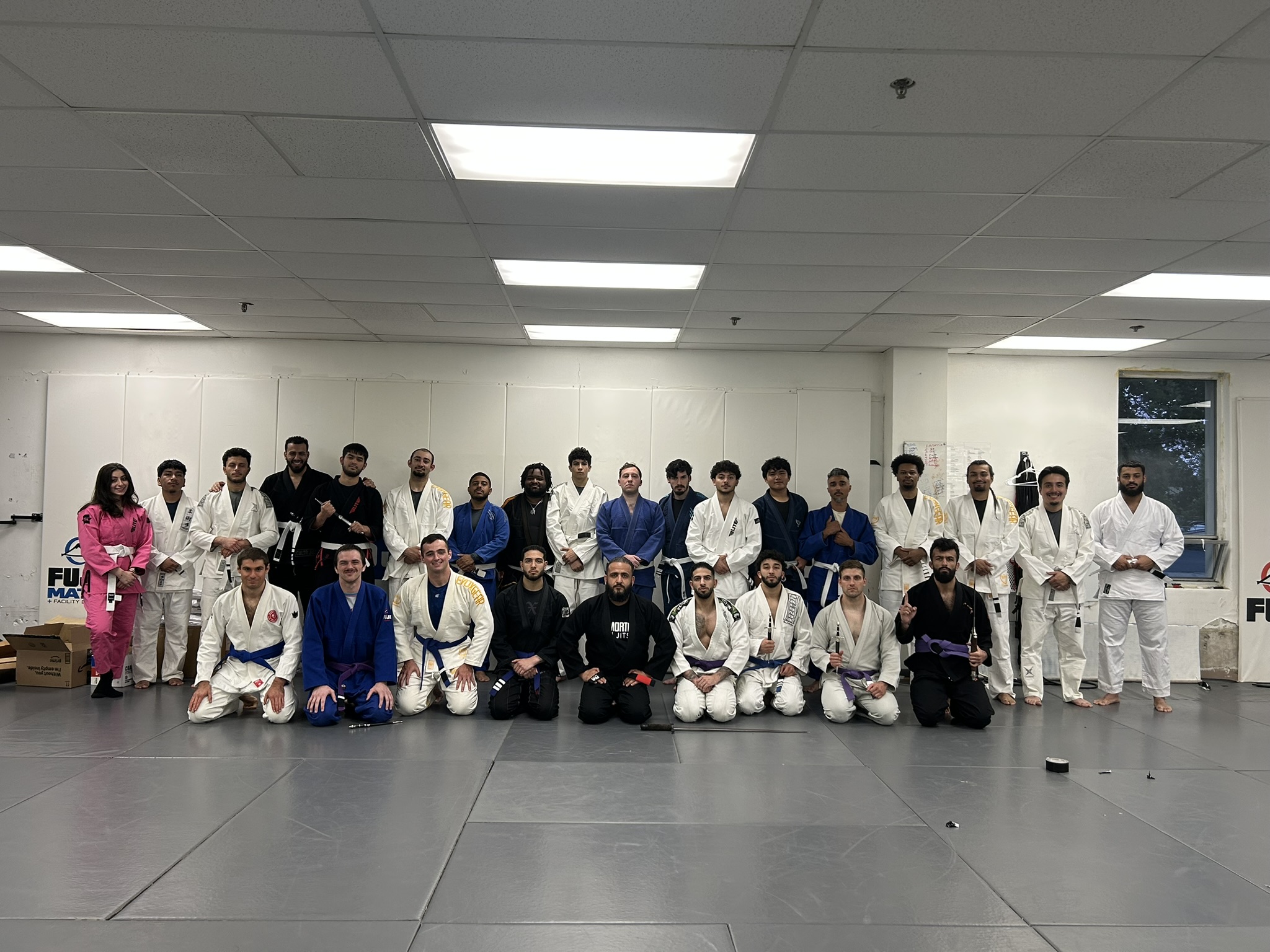Immortals Jiu Jitsu students and coaches gathered together on the mats after a Brazilian jiu jitsu class in Clifton, New Jersey.