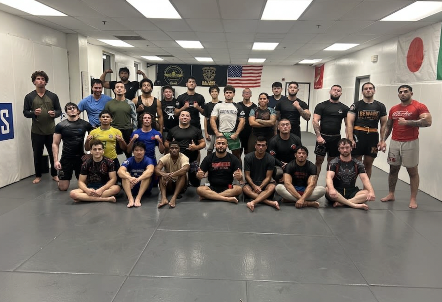 The adult no-gi class at Immortals gathered together on the mats in rashguards after training.