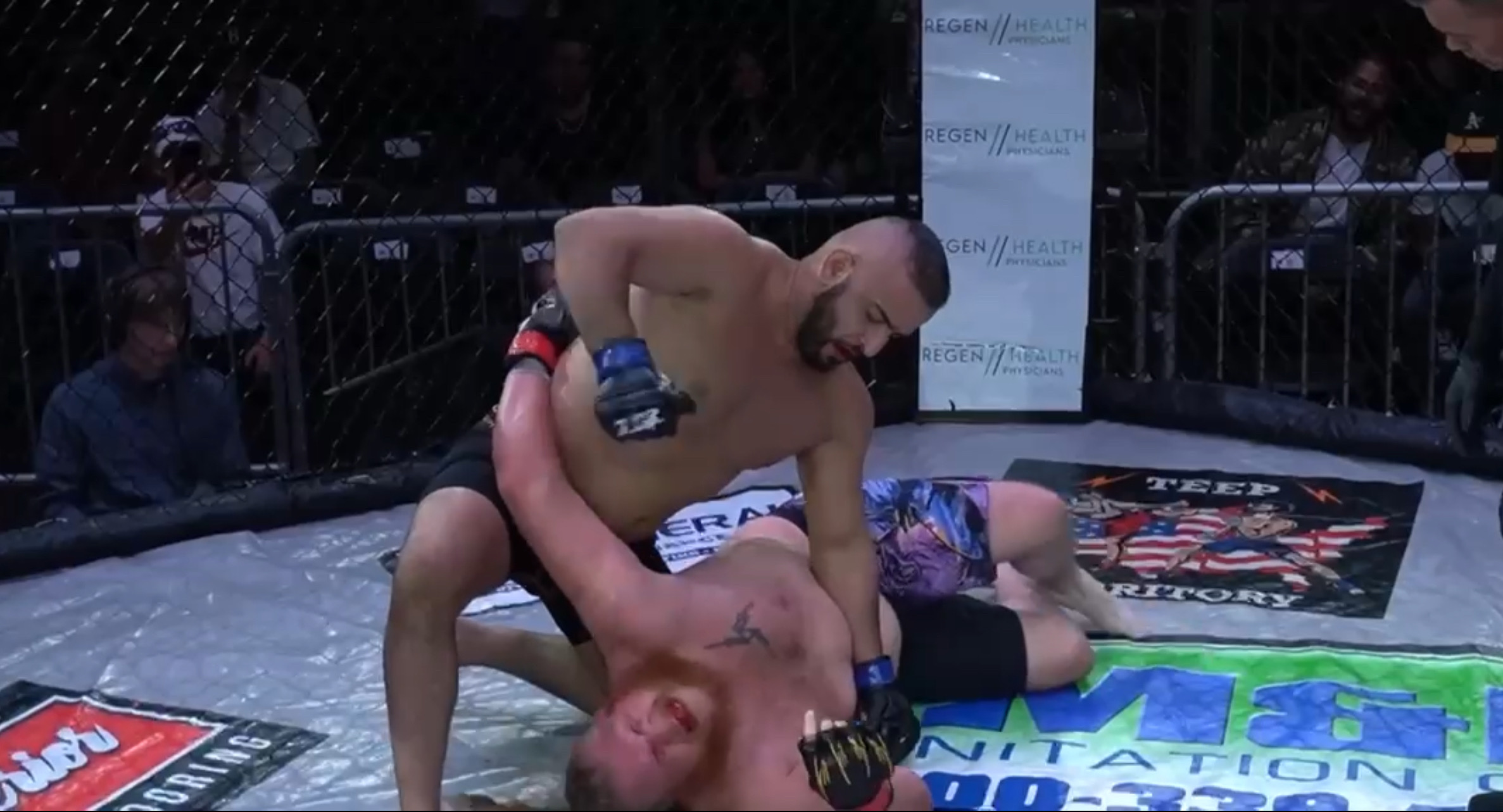 Two fighters grappling in an MMA bout, one landing ground strikes from top position — the no-gi and MMA crossover.