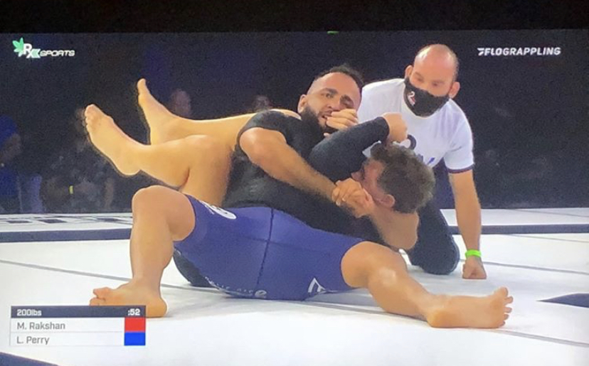 Immortals competitor Mike Rakshan controlling his opponent on the ground during a live grappling match.