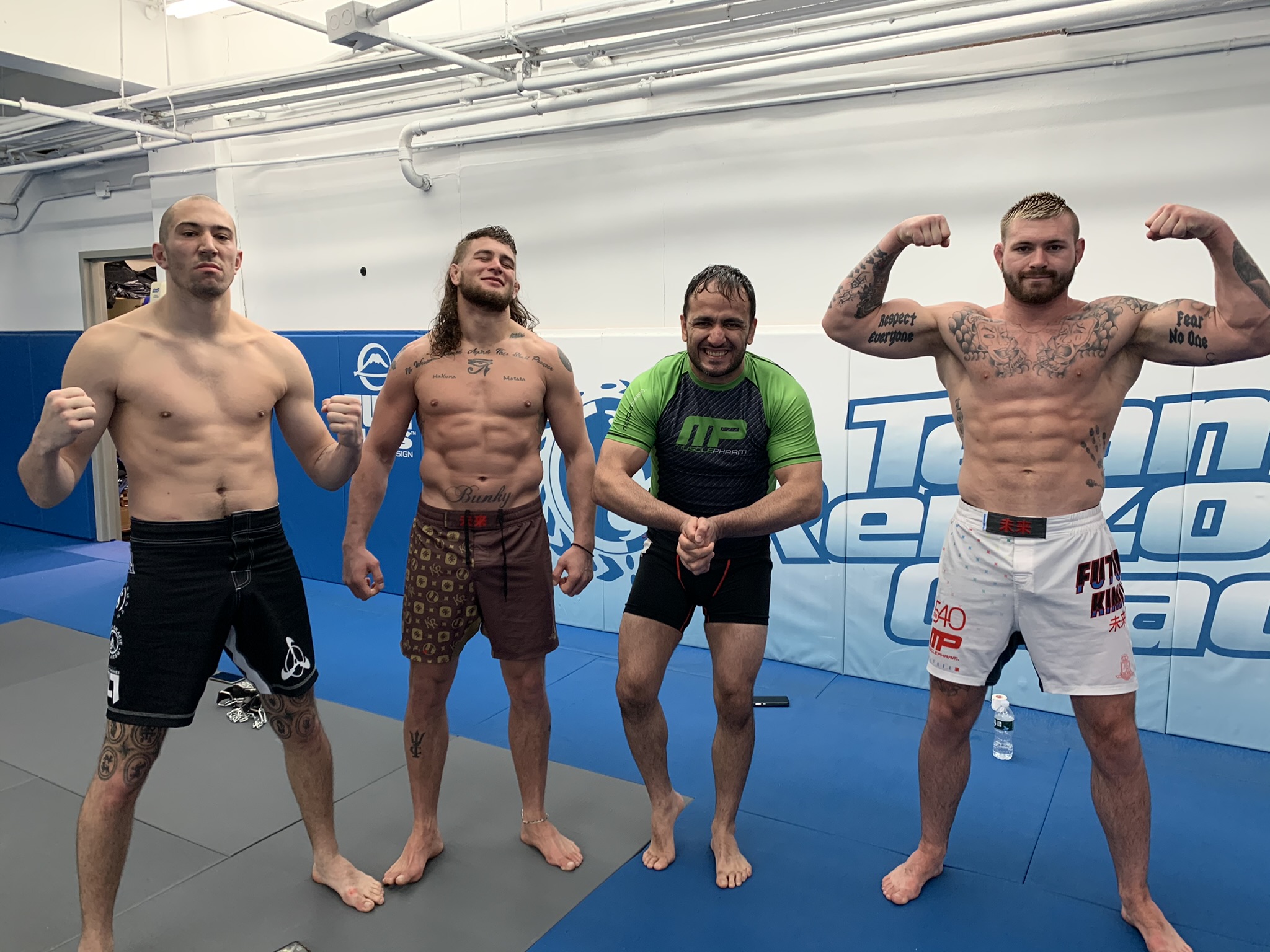 A group of Immortals training partners standing together in the gym after a session.